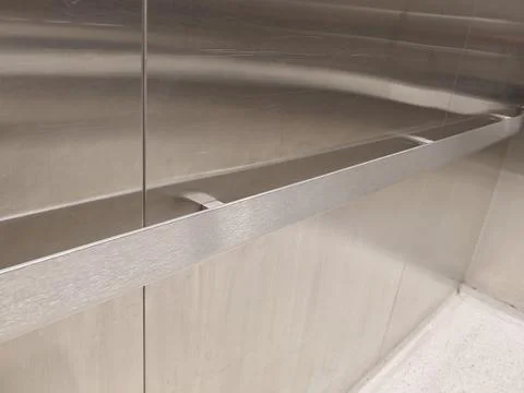 Brushed Stainless Steel Elevator Interior Handrail and Wall Panels Stock-Fotos