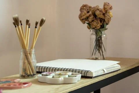 A brushes and notebook ready to paint with watercolor Stock Photos
