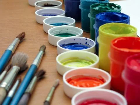 Brushes and paints on table Stock Photos
