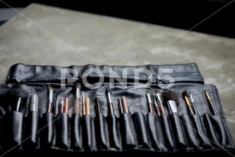 Brushes and pencils in a leather case.The artist's tools. Creativity and Stock Photos