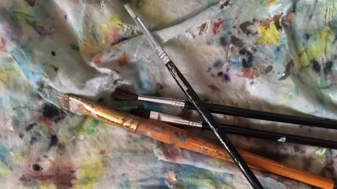 Brushes are thrown onto the canvas, close-up Stock Footage 267301817