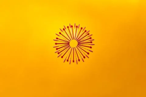 Brushes arranged in a circular pattern on a bright yellow background during.. Stock Photos