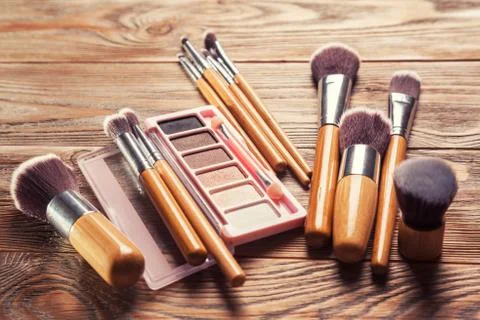 Brushes with cosmetics scattered chaotically Stock Photos