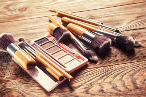 Brushes with cosmetics scattered chaotically Stock Photos