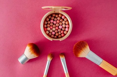 Brushes with cosmetics scattered chaotically Stock Photos