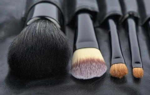 Brushes of Make-Up in a holder from leather Stock Photos