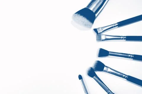 Brushes for makeup lying on white background. PANTONE Blue, Classic Blue Foto stock