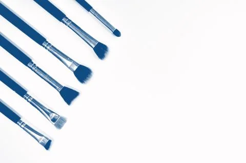 Brushes for makeup lying on white background. PANTONE Blue, Classic Blue Stock Photos