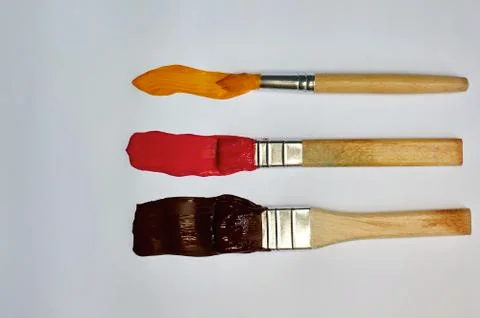 Brushes with paint on a white background Stock Photos