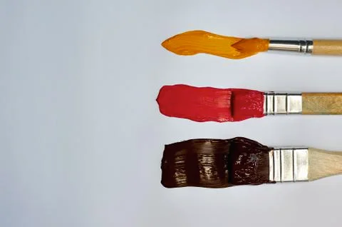 Brushes with paint on a white background Stock Photos