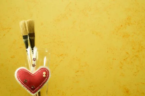 Brushes on a painted wall background. Decorative plaster. Abstract ornament. Stock Photos