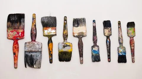 Brushes in paints on a white background Stock Photos