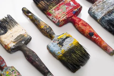 Brushes in paints on a white background Stock Photos