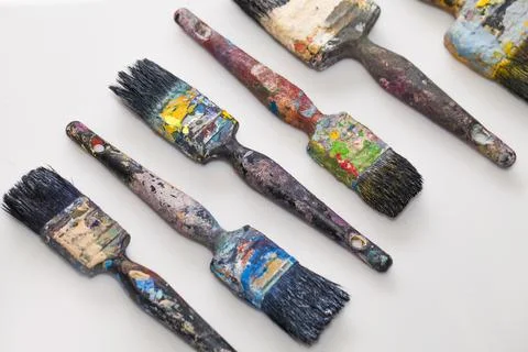 Brushes in paints on a white background Stock Photos