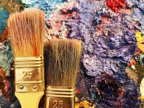 Brushes on the palette Stock Photos