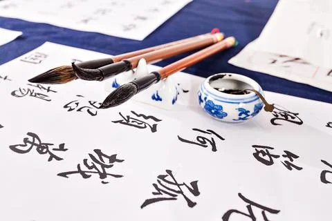 Brushes on a table with white papers Stock Photos
