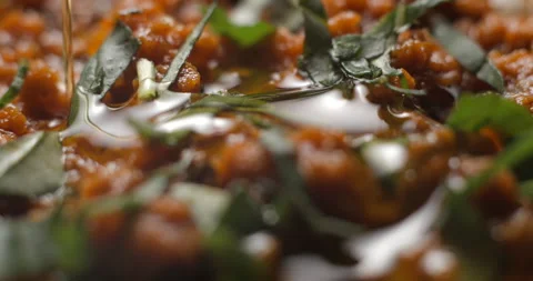 Brushetta tomato preparation rotating with basil pouring slow motion Stock Footage 280519606