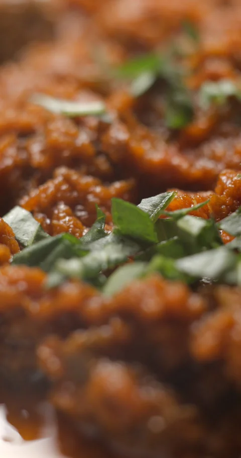 Brushetta tomato preparation rotating with basil pouring slow motion Stock Footage 280519787