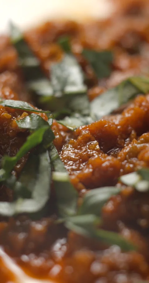 Brushetta tomato preparation rotating with basil pouring slow motion Stock Footage 280519809