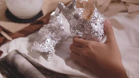 Brushing and layering glue and recycled paper on a bear shape mold made of 스톡 동영상 297952787