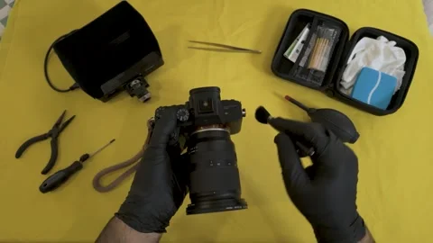 Brushing the buttons and dials of a professional camera. Stock Footage 327624183