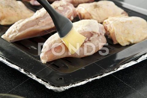 Brushing Chicken with Melted Butter; Chicken on a Broiling Pan Stock Photos