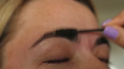 Brushing dyeing eyebrows Stock Footage 135241562