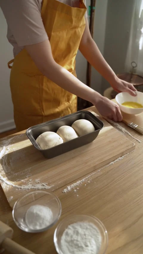 Brushing Egg Wash on Bread: Step-by-Step Baking Technique Stock Footage 300000571