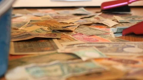 Brushing floor covered with banknotes smooth dolly shot - nonsence concept Stock Footage 87988569