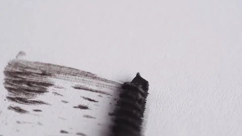 Brushing with mascara on a white background. Stroke of dark brown mascara f.. Video stock 258916404
