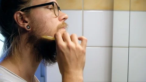 Brushing moustache and beard before trimming moustache in bathroom. Stock Footage