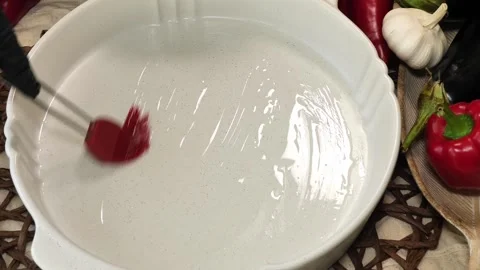 Brushing Oil on White Baking Tray with Red Silicone Brush Stock Footage 311543885