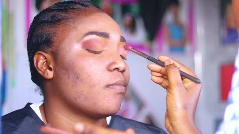 Brushing over eyes of makeup model. Make up treatment on a woman	 Stock Footage 217874948