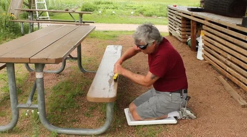 Brushing a picnic table Stock Footage 64455129