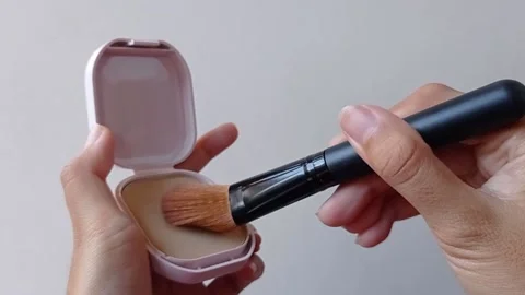 Brushing a powder with a brown brush Stock Footage 145562926