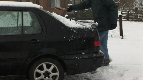 Brushing snow off the car Stock Footage