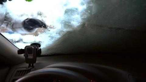 Brushing off snow from car windshield Stock Footage 100878093