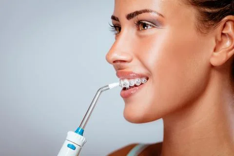 Brushing Teeth With Braces Stock Photos