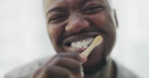 Brushing teeth, cleaning and face of black man with toothbrush for wellness Stock Footage 232486973