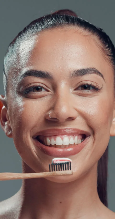Brushing teeth, face and smile of woman in studio for oral care, hygiene or Stock Footage 319071247