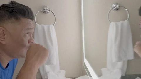 Brushing teeth in front of the mirror Stock Footage 320974292