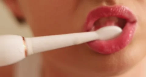 Brushing Teeth with a Paste and Tooth Brush a Close up Shot of Woman Lips. Stock Footage 300365305