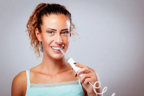 Brushing Teeth With Tooth Irrigator Stock Photos