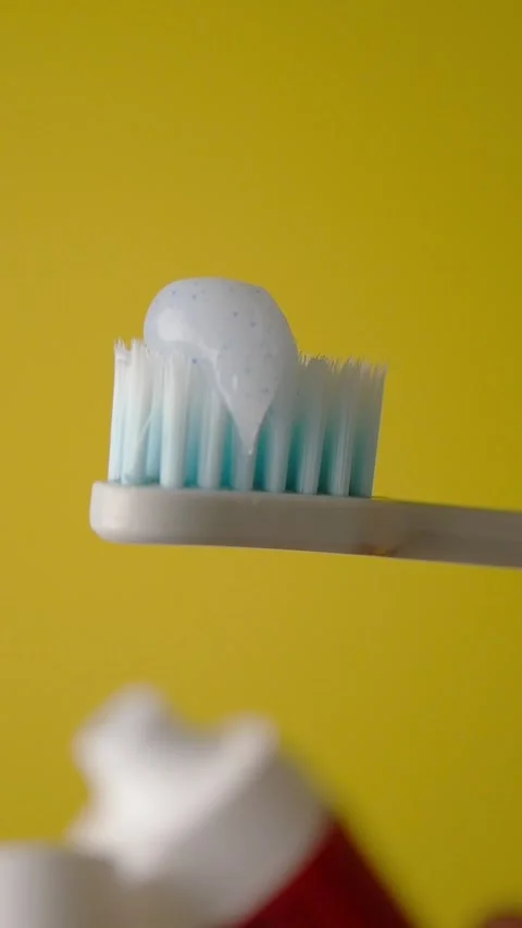 Brushing teeth with toothpaste in a clean bathroom Stock Footage 323150023