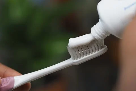 Brushing teeth with toothpaste for a refreshing start Fotos Stock