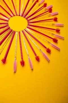 Brushing tools arranged in a circular pattern on a bright yellow surface du.. Stock Photos