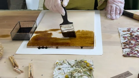 Brushing wood panel for decorative craft with handmade floral paper. Eco-friendl Stock Footage 313518546