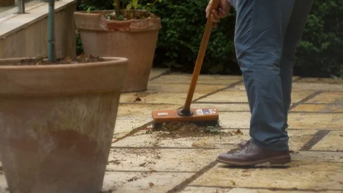 Brushing the yard Stock Footage 94720275