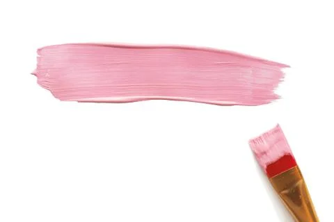 A brushstroke of pink acrylic paint and a paint brush next to it. Isolate on  Stock Photos