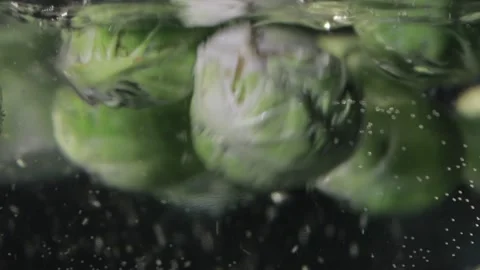 Brussel sprouts are floating in the water. Stock Footage 217998686